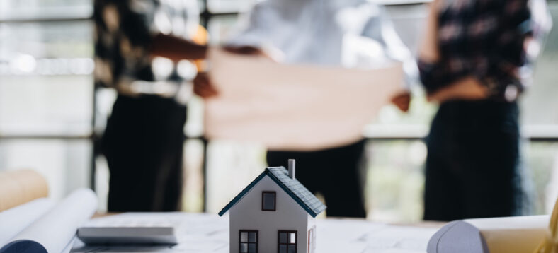 business engineering teamwork discussing a new building project with home model to successful business, selective focus at home model and hand. concept business engineering,architecture.